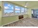 Bright sunroom with large windows offering beautiful views, wood-look floors, and a ceiling fan at 4725 Cove Cir # 302, St Petersburg, FL 33708