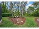 A peaceful backyard area with a bench, stone pathway, mulch beds, and mature trees at 5806 Terncrest Dr, Lithia, FL 33547
