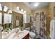 Bathroom with shower, vanity, mirrored cabinet, and decorative shower curtain at 5806 Terncrest Dr, Lithia, FL 33547