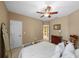 Comfortable bedroom featuring carpet, ceiling fan, neutral decor, and a decorative rocking chair at 5806 Terncrest Dr, Lithia, FL 33547