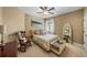 Cozy bedroom featuring neutral tones, a ceiling fan, and a decorative rocking chair at 5806 Terncrest Dr, Lithia, FL 33547