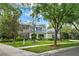 Elegant two-story home featuring stone facade, manicured lawn, mature trees, and inviting curb appeal at 5806 Terncrest Dr, Lithia, FL 33547
