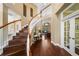 Elegant foyer with curved staircase, hardwood floors, and views into the living areas at 5806 Terncrest Dr, Lithia, FL 33547