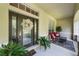 Inviting front porch with comfortable seating and a decorative wreath on the front door at 5806 Terncrest Dr, Lithia, FL 33547
