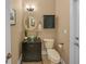 Charming half bathroom with decorative mirror, vessel sink, black cabinet, and neutral wall color at 5806 Terncrest Dr, Lithia, FL 33547