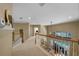 Upstairs hallway with railing overlooking the living room and backyard pool at 5806 Terncrest Dr, Lithia, FL 33547
