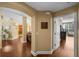 Hallway with wood floors leading to the living room and kitchen at 5806 Terncrest Dr, Lithia, FL 33547