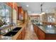 Well-appointed kitchen with granite counters, stainless steel sink, and island with cooktop at 5806 Terncrest Dr, Lithia, FL 33547