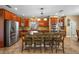 Spacious kitchen with cherry cabinets, center island with range, stainless steel appliances, and tile floors at 5806 Terncrest Dr, Lithia, FL 33547