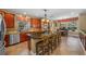Beautiful kitchen with center island, cherry cabinets, stainless steel appliances, and adjacent breakfast nook at 5806 Terncrest Dr, Lithia, FL 33547