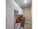 Well-organized laundry room with gray machines, ample cabinet space, bench, and bright lighting at 5806 Terncrest Dr, Lithia, FL 33547