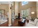 Bright living room with soaring ceilings, large windows, and hardwood floors welcomes natural light at 5806 Terncrest Dr, Lithia, FL 33547