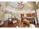 Bright living room features high ceilings, hardwood floors, and comfortable leather furniture at 5806 Terncrest Dr, Lithia, FL 33547