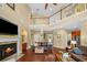 Spacious living room with fireplace, hardwood floors, and an open staircase to the second floor at 5806 Terncrest Dr, Lithia, FL 33547