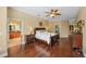 A comfortable main bedroom with wood floors and an ensuite bathroom with dual vanities at 5806 Terncrest Dr, Lithia, FL 33547