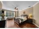 Spacious main bedroom boasts wood floors, a ceiling fan, and large windows offering ample natural light at 5806 Terncrest Dr, Lithia, FL 33547
