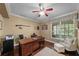 Home office boasts hardwood floors, crown molding, and natural light at 5806 Terncrest Dr, Lithia, FL 33547