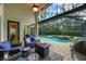 Inviting screened-in pool area with a heated pool, spa, fire pit and outdoor kitchen, perfect for entertaining at 5806 Terncrest Dr, Lithia, FL 33547