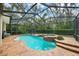 Gorgeous screened-in pool and spa with brick paver decking and lush greenery surrounding the backyard at 5806 Terncrest Dr, Lithia, FL 33547