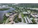 Aerial view of a lush green community with a pool, tennis courts, and access to the waterfront at 600 Reserve Ln, Dunedin, FL 34698