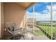 Comfortable seating on screened balcony featuring views of lush landscaping and clear waters at 600 Reserve Ln, Dunedin, FL 34698