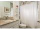 Bathroom with a marble countertop vanity and a shower with stone tile at 600 Reserve Ln, Dunedin, FL 34698