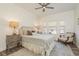 Comfortable bedroom with cozy decor, a ceiling fan, and natural lighting at 600 Reserve Ln, Dunedin, FL 34698
