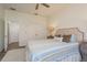 Bedroom featuring wood look flooring, a ceiling fan, and a double-door closet at 600 Reserve Ln, Dunedin, FL 34698