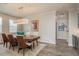 Stylish dining room features wood flooring, table with six chairs, and modern light fixture at 600 Reserve Ln, Dunedin, FL 34698