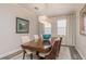 Elegant dining room with a wood table, six chairs, and a stylish light fixture at 600 Reserve Ln, Dunedin, FL 34698