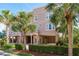 Charming three-story home with unique architectural details and lush tropical landscaping at 600 Reserve Ln, Dunedin, FL 34698