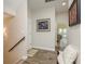 Bright hallway with staircase, artwork, and access to living areas at 600 Reserve Ln, Dunedin, FL 34698