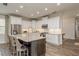 Bright kitchen with stainless steel appliances, granite countertops, and a center island with bar seating at 600 Reserve Ln, Dunedin, FL 34698