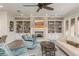 Cozy living room featuring a fireplace, built-in bookshelves, and neutral decor at 600 Reserve Ln, Dunedin, FL 34698