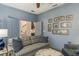 Comfortable living room featuring a stylish sofa, framed pictures, and an open doorway at 600 Reserve Ln, Dunedin, FL 34698