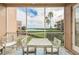 Balcony featuring seating and views of the water and palm trees at 600 Reserve Ln, Dunedin, FL 34698
