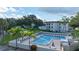 Beautiful swimming pool area with lounge chairs and palm trees in a tropical setting at 600 Reserve Ln, Dunedin, FL 34698