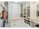 Spacious walk-in closet with custom shelving, drawers, and center island at 600 Reserve Ln, Dunedin, FL 34698