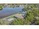 Aerial view of waterfront property featuring a screened pool and lush backyard bordering a tranquil lake at 601 Riviera Bay Ne Dr, St Petersburg, FL 33702