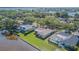 Aerial view showcasing waterfront homes with screened patios, lush lawns, and peaceful lake scenery at 601 Riviera Bay Ne Dr, St Petersburg, FL 33702