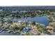 Aerial view of a lakeside community surrounded by trees and a large body of water at 601 Riviera Bay Ne Dr, St Petersburg, FL 33702