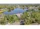 Aerial view showcasing a home with a large lake and surrounded by lush trees and greenery at 601 Riviera Bay Ne Dr, St Petersburg, FL 33702