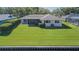Spacious backyard with lush green grass, waterfront access, and neatly trimmed hedges at 601 Riviera Bay Ne Dr, St Petersburg, FL 33702