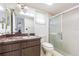 Bathroom featuring a skylight, a vanity with ample storage and a glass enclosed shower at 601 Riviera Bay Ne Dr, St Petersburg, FL 33702
