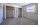 Bedroom with a set of closets with shelving and a window that provides light at 601 Riviera Bay Ne Dr, St Petersburg, FL 33702