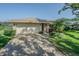 Charming single-story brick home with a spacious driveway, well-manicured lawn, and mature landscaping at 601 Riviera Bay Ne Dr, St Petersburg, FL 33702