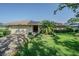 Charming single-story home featuring a well-manicured lawn and brick driveway at 601 Riviera Bay Ne Dr, St Petersburg, FL 33702