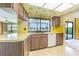 Retro kitchen with wood cabinets, yellow countertops, and a view of the lake at 601 Riviera Bay Ne Dr, St Petersburg, FL 33702