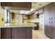Kitchen with wood cabinets, tile flooring, and yellow backsplash at 601 Riviera Bay Ne Dr, St Petersburg, FL 33702