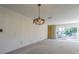 Bright living room with an ornate chandelier and large windows at 601 Riviera Bay Ne Dr, St Petersburg, FL 33702